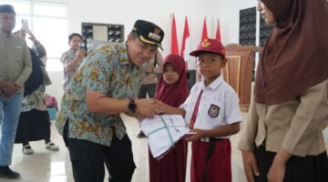 Bentuk Komitmen,Bupati Iksan Serahkan 500 Seragam Sekolah Gratis di Menui Kepulauan